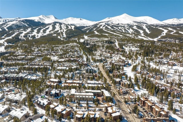 snowy aerial view featuring a mountain view