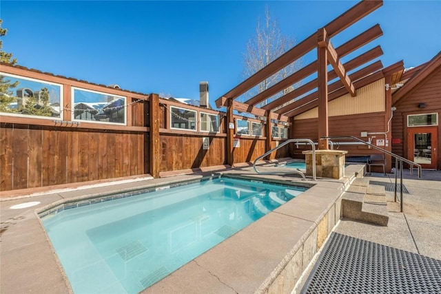 view of pool featuring an in ground hot tub, fence, and a patio