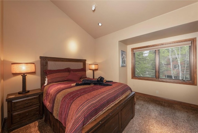 bedroom with baseboards, lofted ceiling, and carpet