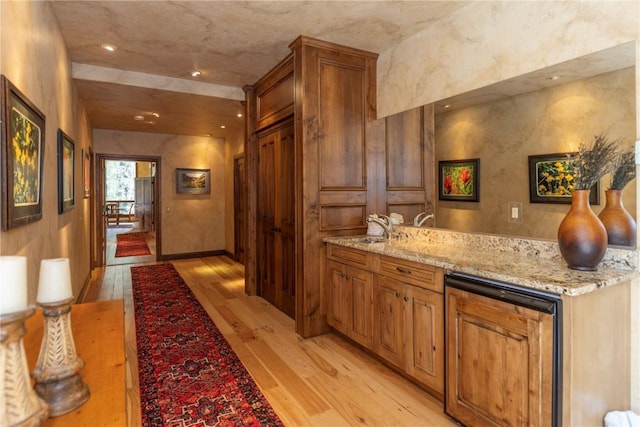 interior space featuring recessed lighting, light wood-type flooring, and a sink