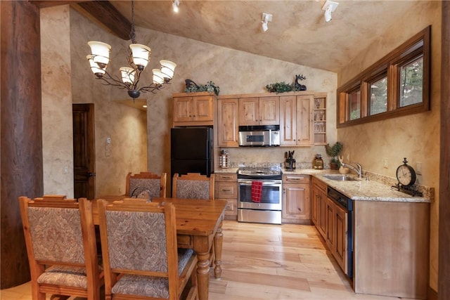 kitchen with light wood-type flooring, a sink, stainless steel appliances, light stone countertops, and a chandelier