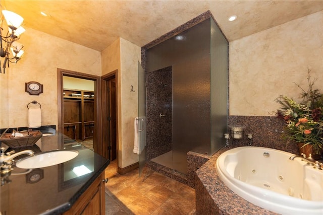 bathroom featuring a stall shower, vanity, and a whirlpool tub