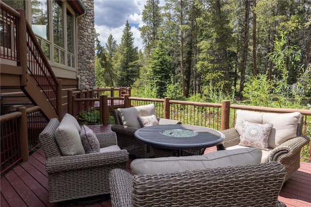 wooden terrace with an outdoor hangout area