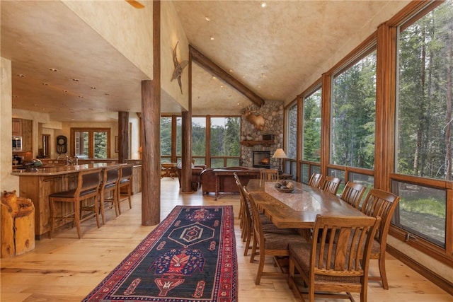 dining room with a fireplace and light wood-style floors