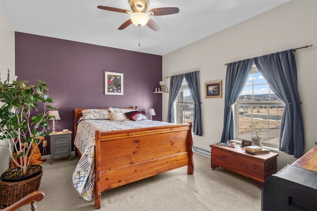 bedroom featuring baseboard heating, ceiling fan, carpet floors, and multiple windows