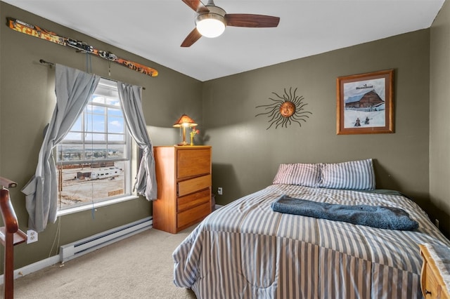 carpeted bedroom with a baseboard radiator and ceiling fan