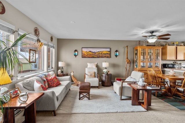 living room featuring light carpet and ceiling fan