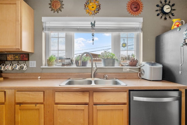 kitchen with sink, dishwasher, and light brown cabinets