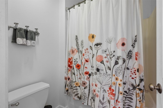 bathroom with toilet and curtained shower