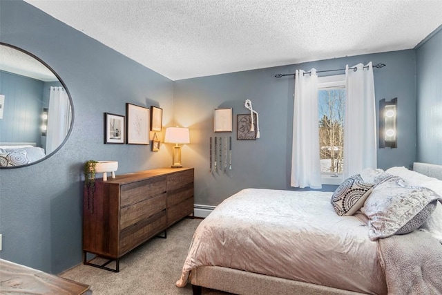 bedroom with light colored carpet, a textured ceiling, and baseboard heating