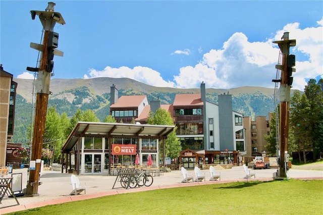 view of community featuring a mountain view and a yard