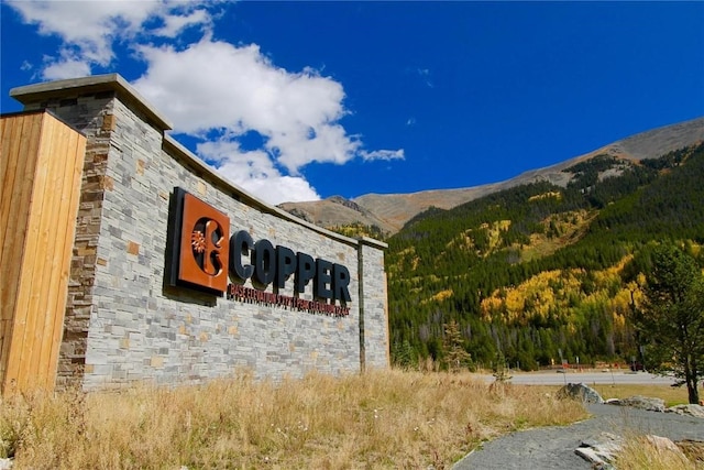 community sign with a mountain view