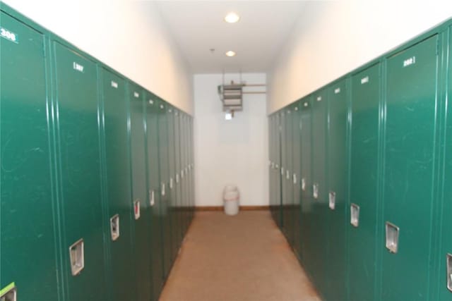 corridor featuring light colored carpet