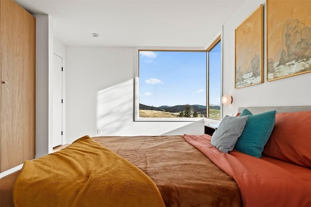 bedroom featuring a mountain view