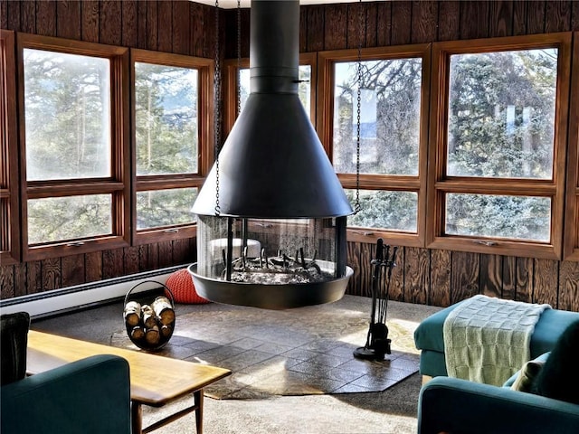 sunroom featuring a baseboard heating unit