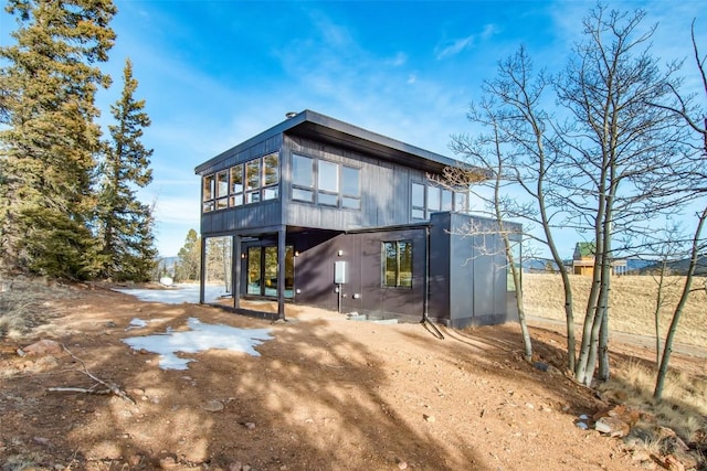 back of property featuring a sunroom