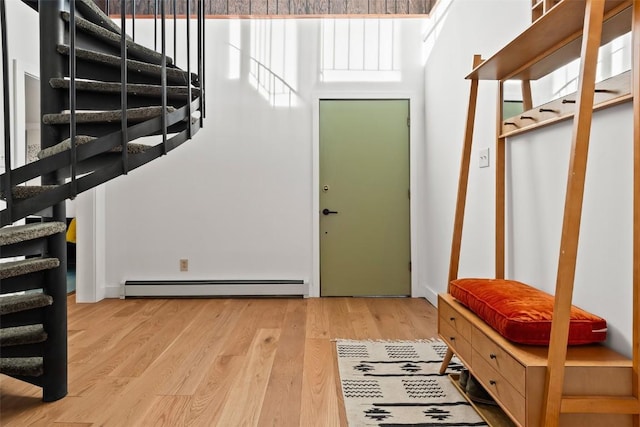 entrance foyer with light hardwood / wood-style floors and baseboard heating