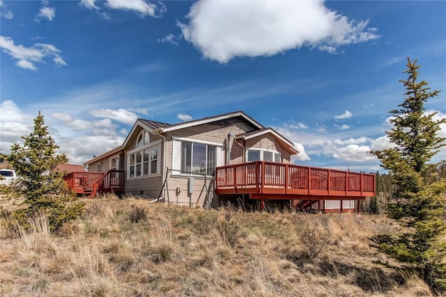 back of house with a wooden deck