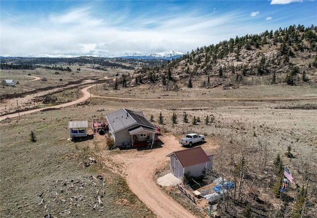 drone / aerial view featuring a mountain view and a rural view