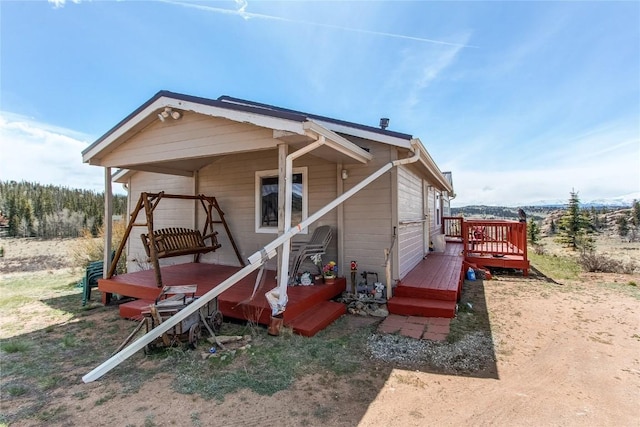 back of house with a wooden deck