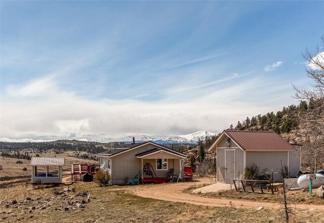 exterior space featuring a mountain view and a shed