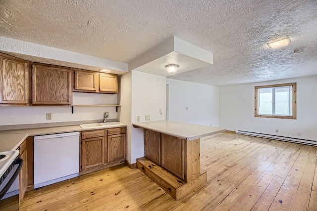 kitchen featuring sink, white appliances, a baseboard heating unit, kitchen peninsula, and light wood-type flooring