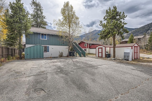 exterior space with a shed and a mountain view