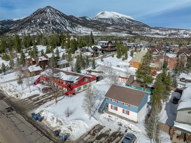 snowy aerial view with a mountain view