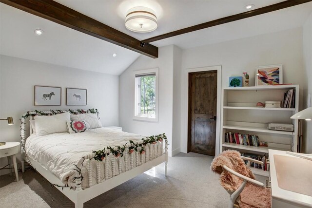 bedroom with vaulted ceiling with beams and carpet floors