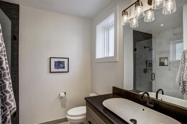 bathroom featuring vanity, toilet, and walk in shower