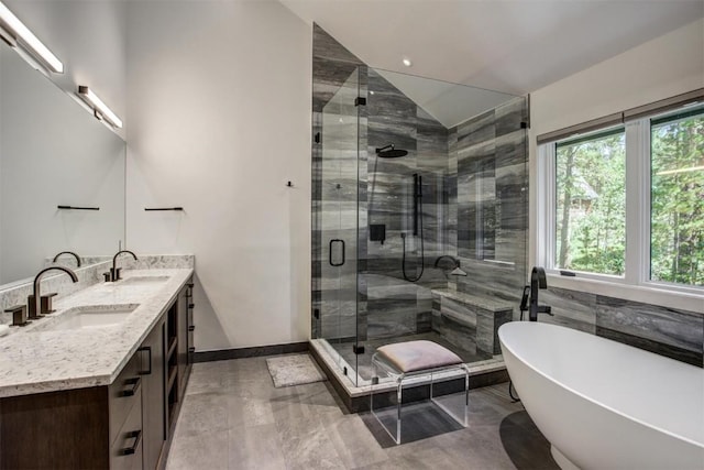 bathroom with vanity, independent shower and bath, and lofted ceiling