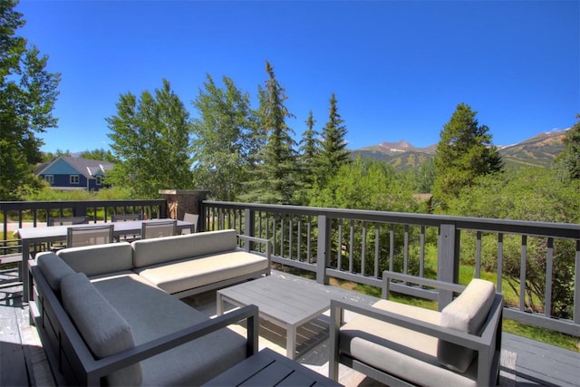 wooden terrace featuring an outdoor living space and a mountain view