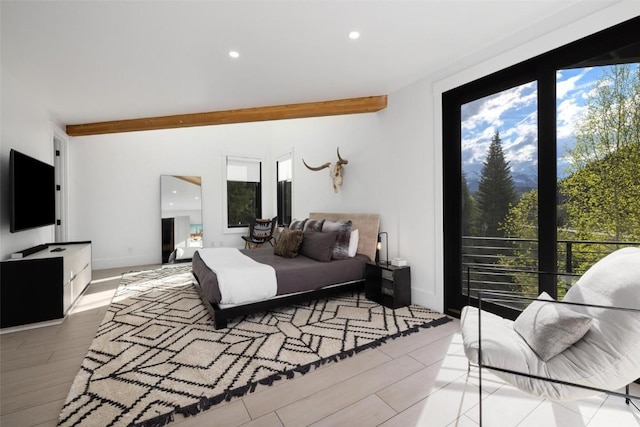 bedroom featuring beamed ceiling and light hardwood / wood-style floors