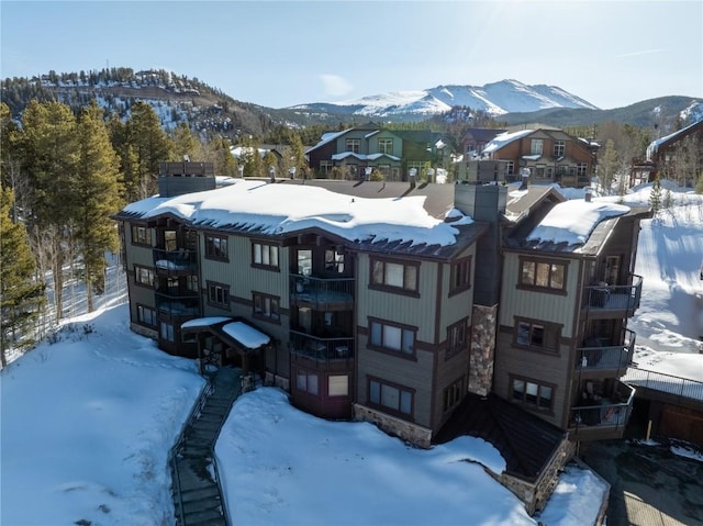 snowy aerial view featuring a mountain view