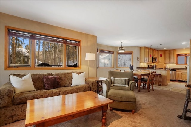 living area featuring recessed lighting and light colored carpet