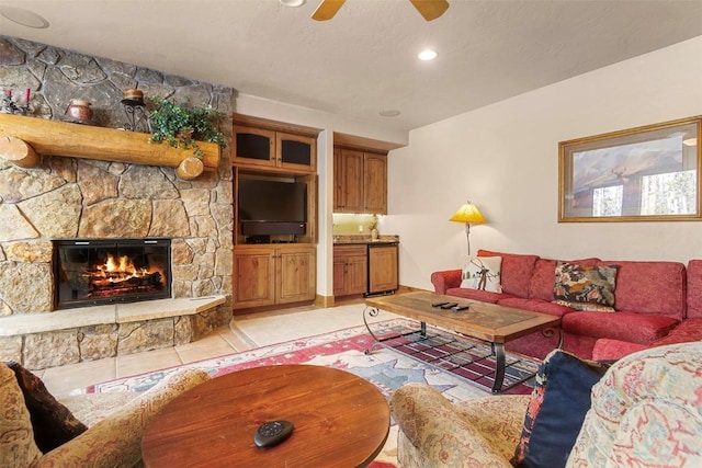 living room with light tile patterned floors, a stone fireplace, recessed lighting, and a ceiling fan