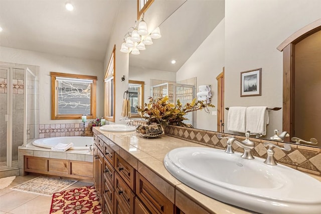 bathroom featuring a sink, a garden tub, a shower stall, and tile patterned flooring