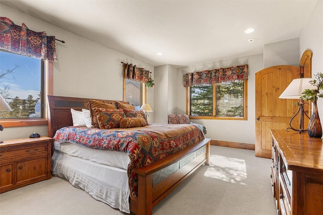 bedroom featuring light carpet, recessed lighting, and baseboards