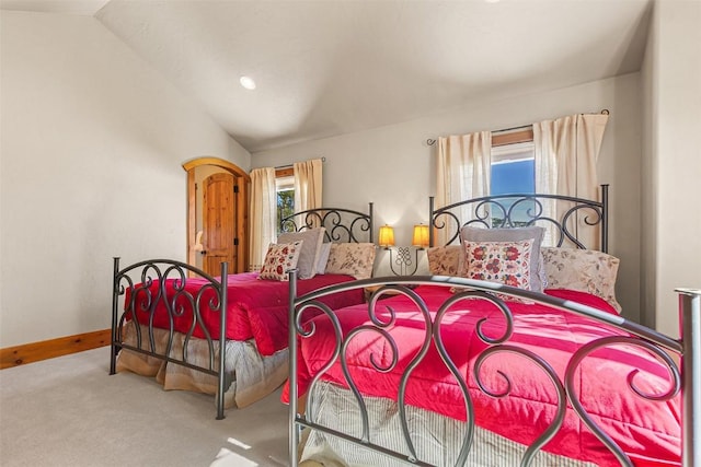 bedroom featuring multiple windows, carpet flooring, and vaulted ceiling