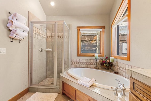 bathroom featuring tile patterned floors, a garden tub, and a stall shower