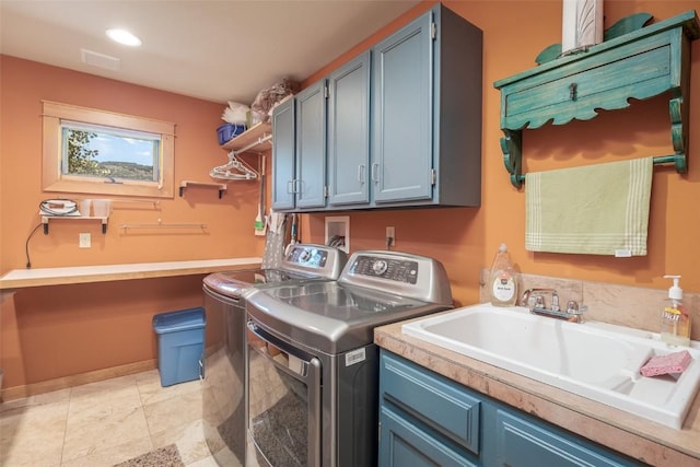 clothes washing area featuring cabinets, separate washer and dryer, sink, and light tile patterned floors