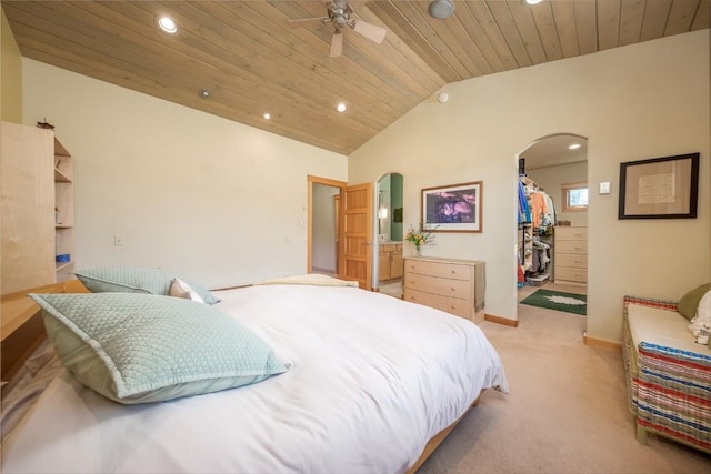 bedroom with ensuite bathroom, vaulted ceiling, ceiling fan, a spacious closet, and wood ceiling