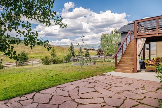 view of patio / terrace with a mountain view and a rural view