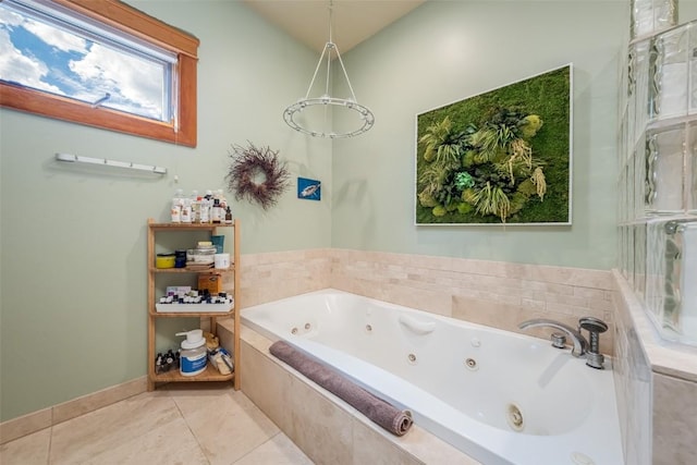 bathroom with tile patterned flooring and a relaxing tiled tub