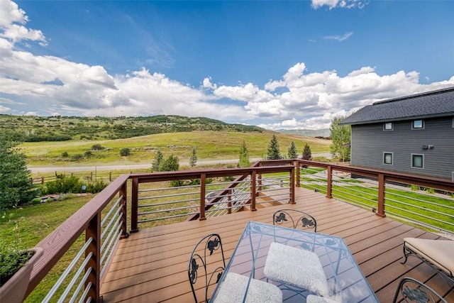 wooden terrace featuring a rural view