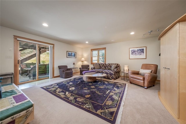 living room with light carpet and track lighting