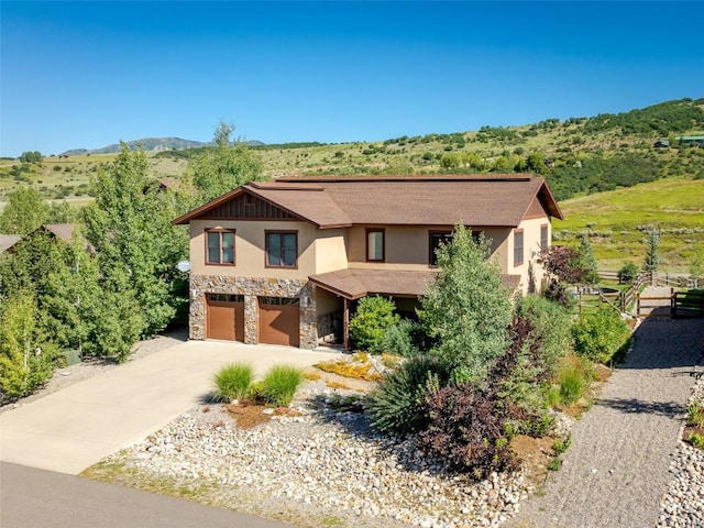 view of front facade featuring a garage and a mountain view