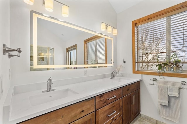 bathroom with vanity and lofted ceiling