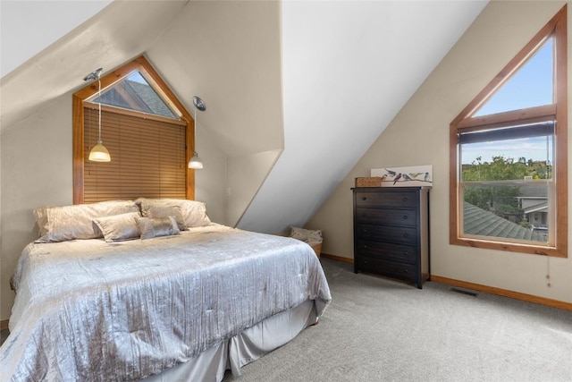 carpeted bedroom with lofted ceiling