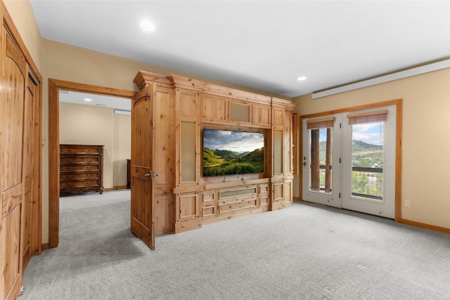 unfurnished living room featuring light colored carpet